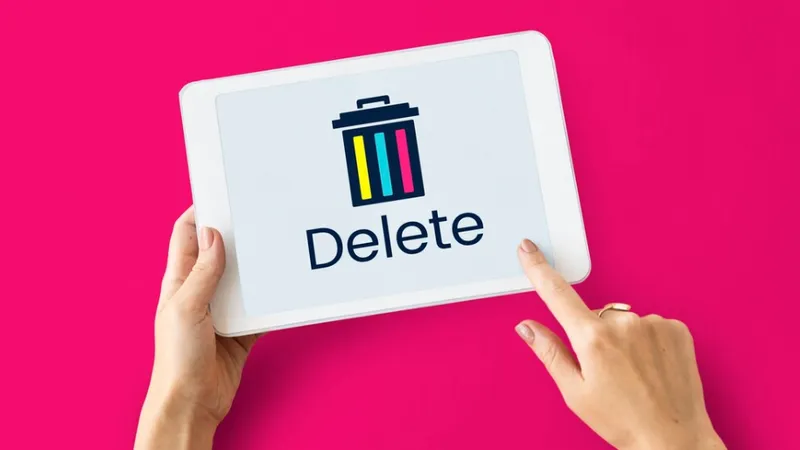 person tap delete on laptop